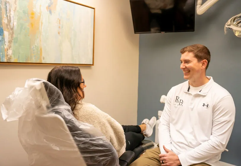 Lenexa, KS dentist Dr. Austin Rickabaugh discussing dental treatment with a patient