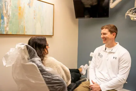 Lenexa, KS dentist Dr. Austin Rickabaugh discussing dental treatment with a patient