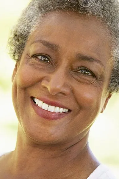 woman smiling after crowns from Rosehill Dentistry helped restore her smile